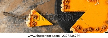 cake spatula with delicious thanksgiving pie decorated with walnuts on stone surface, banner