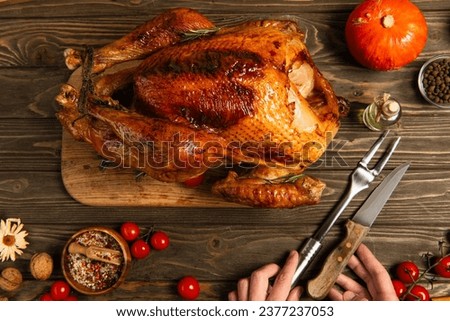 cropped view of man near knife and culinary fork near thanksgiving turkey and spices on wooden table