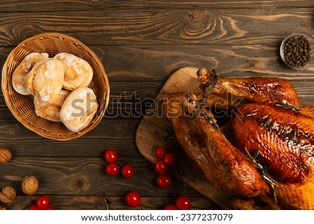 thanksgiving backdrop, grilled turkey with freshly baked buns near cherry tomatoes on wooden table