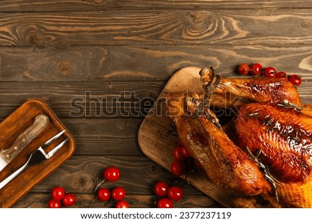 thanksgiving cuisine backdrop, grilled turkey near cutlery and red cherry tomatoes on wooden table