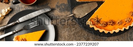 thanksgiving still life, pumpkin pie near black plate and vintage cutlery on stone surface, banner