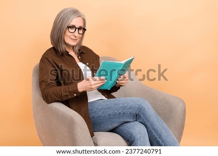 Photo of senior woman grandmother read new literature explore new information nature science discovery isolated on beige color background