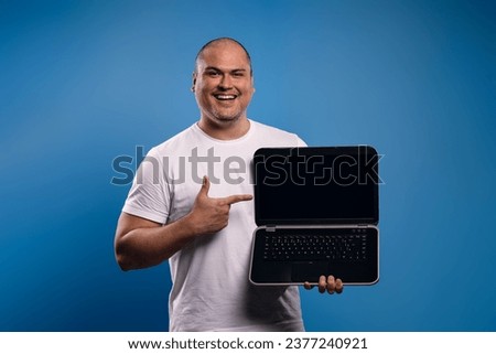 man holding a notebook and pointing at it