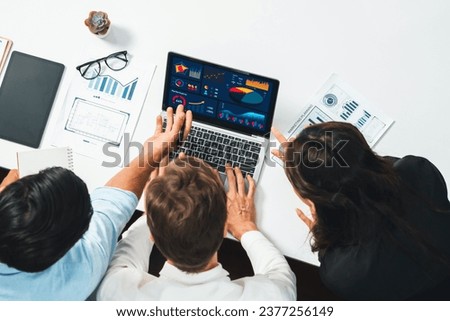 Top view workspace of analyst team uses BI Fintech display laptop to analyze financial data . Business people analyze BI software technology dashboard power for insights business power. Prudent Royalty-Free Stock Photo #2377256149