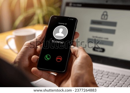 phishing - hands holding phone with incoming call from scammer Royalty-Free Stock Photo #2377264883