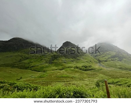 Powerful mountain peaks pictured together as sisters on a foggy day in the Scottish Highlands