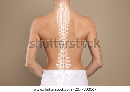 Woman with healthy back on beige background, closeup. Illustration of spine Royalty-Free Stock Photo #2377303067