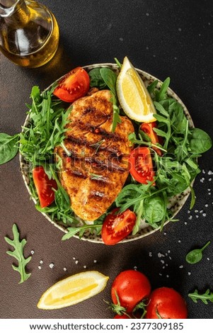 Roasted Chicken Fillet, green lettuce, arugula, tomatoes. Ketogenic diet. Low carb high fat breakfast. Healthy food concept. place for text, top view. Royalty-Free Stock Photo #2377309185