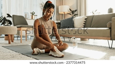 Woman, home and lace shoes for exercise, workout and performance for wellness, action or power. Happy indian girl tie sneakers, footwear and prepare for sports, fitness and healthy training in lounge Royalty-Free Stock Photo #2377314475
