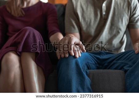 closeup of man woman holding hands  showing support and love  Royalty-Free Stock Photo #2377316915