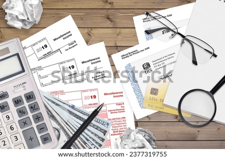 IRS form 1099-MISC Miscellaneous income lies on flat lay office table and ready to fill. U.S. Internal revenue services paperwork concept. Time to pay taxes in United States. Top view Royalty-Free Stock Photo #2377319755