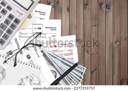 IRS form 1099-MISC Miscellaneous income lies on flat lay office table and ready to fill. U.S. Internal revenue services paperwork concept. Time to pay taxes in United States. Top view Royalty-Free Stock Photo #2377319757
