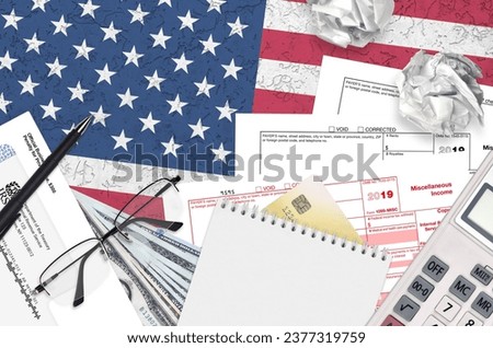 IRS form 1099-MISC Miscellaneous income lies on flat lay office table and ready to fill. U.S. Internal revenue services paperwork concept. Time to pay taxes in United States. Top view Royalty-Free Stock Photo #2377319759