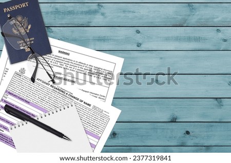 Department of State form DS60 Affidavit Regarding a change of name lies on table and ready to fill. Paperwork during operations with US Passport concept. Flat lay top view Royalty-Free Stock Photo #2377319841