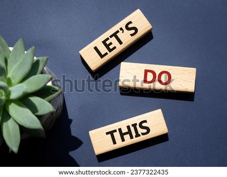 Lets do this symbol. Concept word Lets do this on wooden blocks. Beautiful deep blue background with succulent plant. Business and Lets do this concept. Copy space