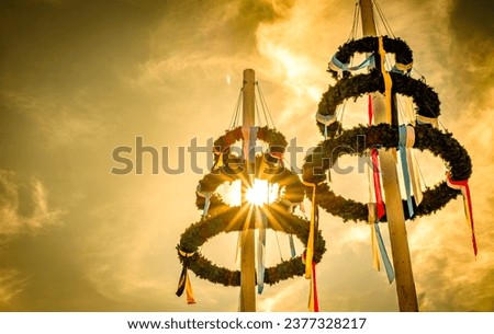 typical bavarian maypole in front of blue sky - photo Royalty-Free Stock Photo #2377328217