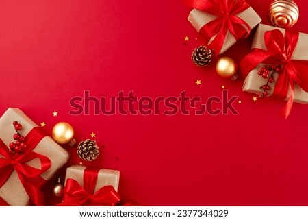 Let the gift-hunting commence: make holiday memories today. Top view shot of elegant gift boxes, holiday decor, cones, sparkles on red background with marketing space