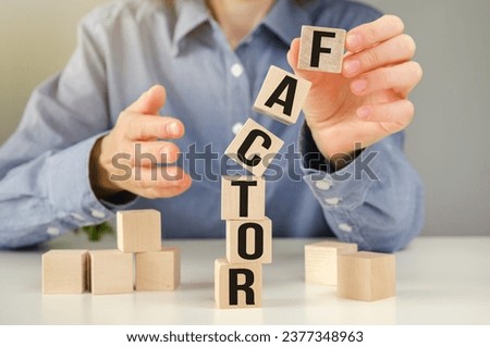 Pull or push factor symbol. Concept word Pull factor and Push factor on wooden cubes. Beautiful grey table grey background. Businessman hand. Business pull or push factor concept.