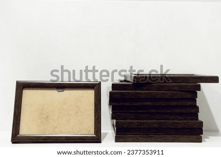 empty photo frames on the wall. brown photo frames. standard size