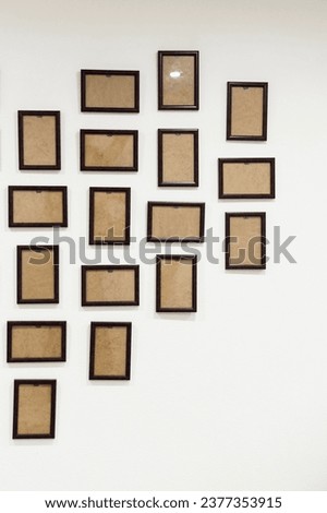 empty photo frames hang on the wall in the shape of a heart. place for photos. dark brown wooden photo frame