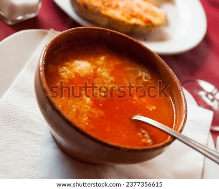 Clay bowl of Castilian garlic soup rich with bread, stringy egg and punchy broth. Spanish cuisine.. Royalty-Free Stock Photo #2377356615