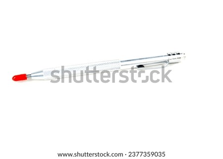 Bright aluminum colored scribe tool with protective rubber tip Royalty-Free Stock Photo #2377359035