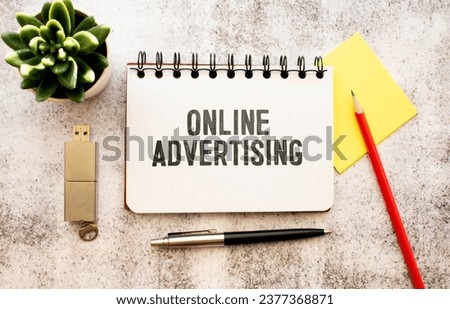 Online Advertising text on a white folder on grey background.