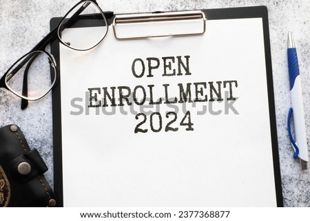 open enrollment 2024. text on a sticker next to money and banknotes Royalty-Free Stock Photo #2377368877