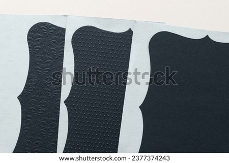layered elegant card inserts with wavy or parenthesis-like edges on gray and blank paper Royalty-Free Stock Photo #2377374243
