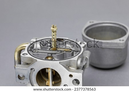 Dirty carburetor parts. Small engine and lawn mower repair, maintenance and tune up. Royalty-Free Stock Photo #2377378563