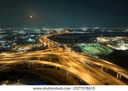Above view of wide highway crossroads in Tampa, Florida at night with fast driving cars. USA transportation infrastructure concept