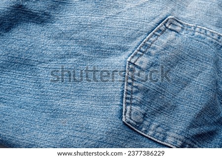 Jeans Fabric Pattern Background: Jeans Background Image Creating a background picture with a fabric pattern for jeans can add a unique and stylish touch to your design. Here's how you can describe the Royalty-Free Stock Photo #2377386229