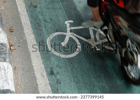 bicycle lanes designated for cyclists, traffic signs painted on the road floor. 