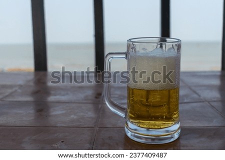 Picture of glass mug filled with beer. Chilled alcohol, cold, soft drink, coca cola, pepsi, soda, beach, bar, enjoy, waiter, hotel, restaurant, pub, men, party, life, pint, pitcher, half, full, rocks.