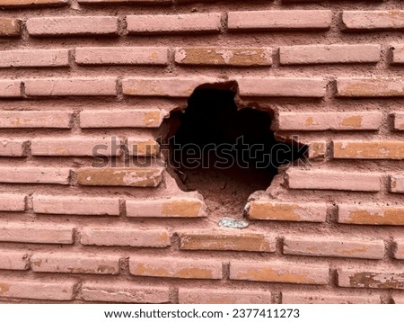 brick house with a hole in the wall
