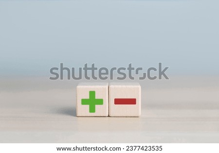 wood block shows icon plus and minus, the concept of comparing pros and cons, opposite negative positive. to choose plus vs minus, decision versus good and bad Royalty-Free Stock Photo #2377423535
