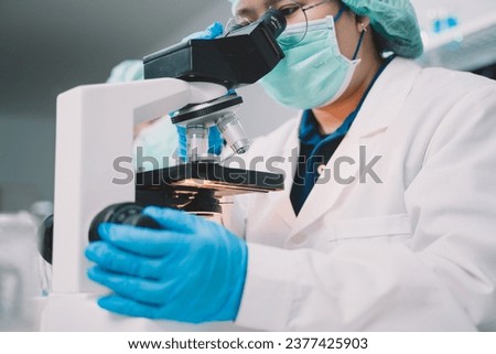 Food scientist or two researcher testing milk samples of dairy products in the laboratory. Researchers are looking and compare milk. Royalty-Free Stock Photo #2377425903