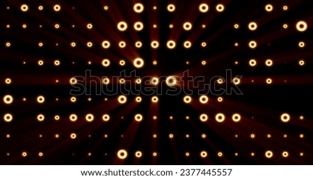 Abstract background of bright orange yellow glowing light bulbs from circles and dots of energy magic disco wall.
