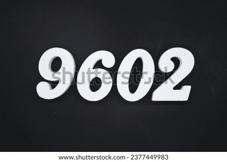 Black for the background. The number 9602 is made of white painted wood.