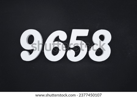 Black for the background. The number 9658 is made of white painted wood.
