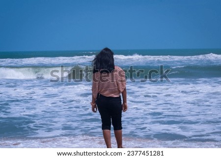 selective focus picture of a woman standing near the beach