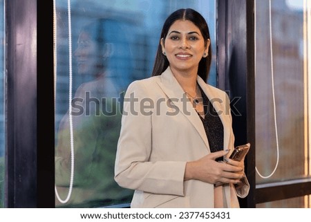 Happy businesswoman looking at camera Royalty-Free Stock Photo #2377453431