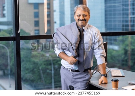 Successful businessman looking at camera
