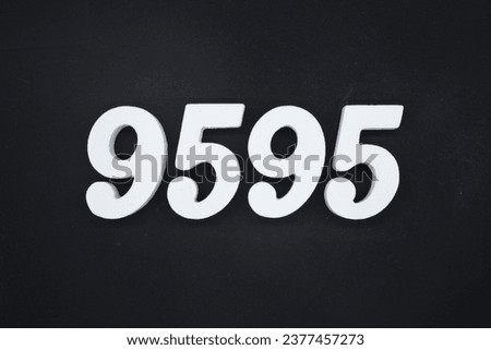 Black for the background. The number 9595 is made of white painted wood.