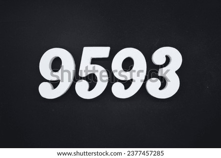 Black for the background. The number 9593 is made of white painted wood.