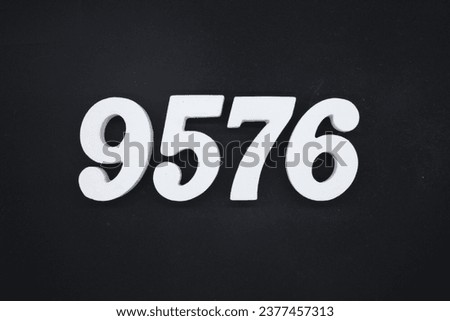 Black for the background. The number 9576 is made of white painted wood.