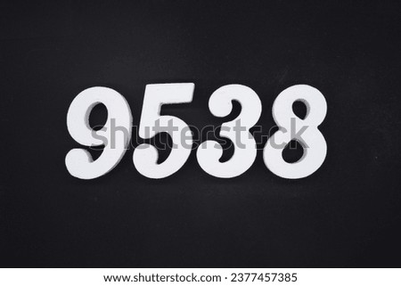 Black for the background. The number 9538 is made of white painted wood.
