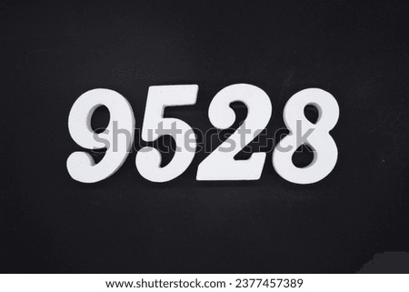 Black for the background. The number 9528 is made of white painted wood.