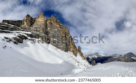 Panoramic view of Tofana di Mezzo in the Dolomites Alps, Italy. Snow blankets the iconic peak, showcasing the serene beauty of this UNESCO World Heritage site.