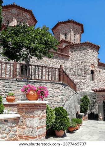 Meteora Greece. The peaceful atmosphere of monastery courtyard. Travel, vacation. Vertical photo. Copy space.